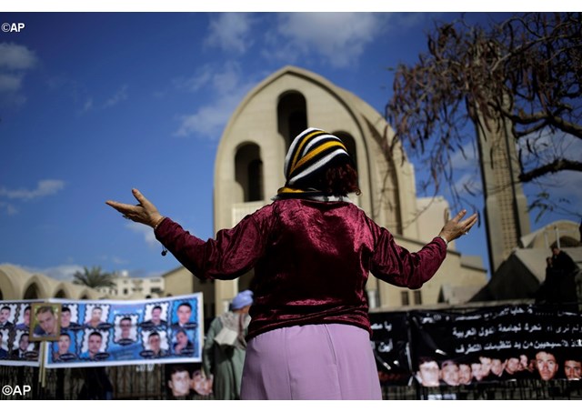 Một phụ nữ cầu nguyện cho 21 người Kitô hữu bị quân khủng bố IS giết hại bên ngoài một nhà thờ ở Cairo, Ai Cập